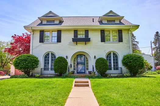 Elegant two-story home in Fort Wayne's South Wayne Historic District, showcasing traditional architecture and vibrant landscaping.