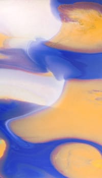 Swirls of vibrant blue, pink, and white merge fluidly, resembling an abstract wave under the soft, glowing light of late afternoon.