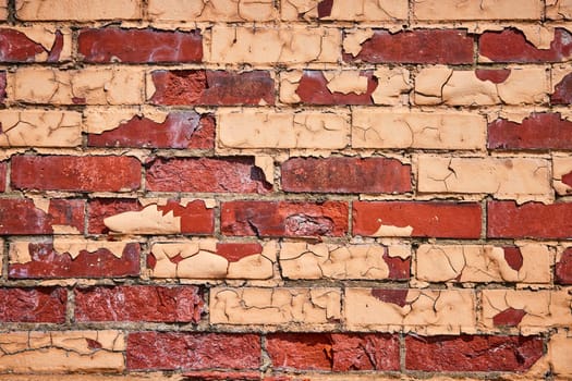 Aged brick wall in Warsaw, Indiana, displaying rich textures of decay and history.