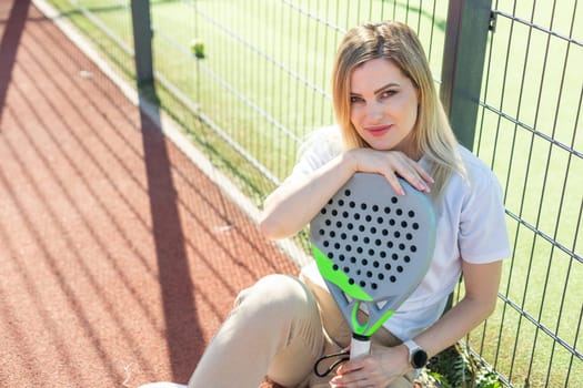 A female paddle tennis player after playing a match. High quality photo