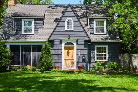 Charming suburban home in Fort Wayne, with lush landscaping and traditional architecture, under clear skies.