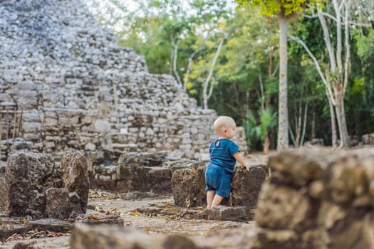 Baby tourist at Coba, Mexico. Ancient mayan city in Mexico. Coba is an archaeological area and a famous landmark of Yucatan Peninsula. Cloudy sky over a pyramid in Mexico.