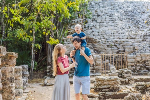 Mom, dad and baby tourists at Coba, Mexico. Ancient mayan city in Mexico. Coba is an archaeological area and a famous landmark of Yucatan Peninsula. Cloudy sky over a pyramid in Mexico.