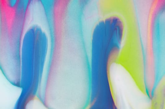 Swirls of vibrant blue, pink, and white merge fluidly, resembling an abstract wave under the soft, glowing light of late afternoon.
