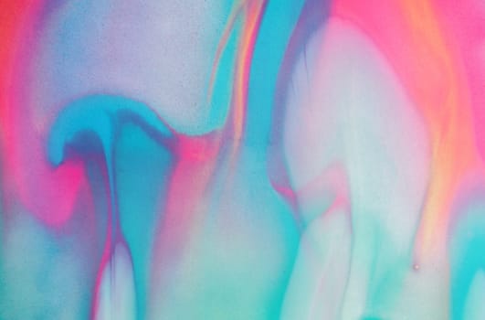 Swirls of vibrant blue, pink, and white merge fluidly, resembling an abstract wave under the soft, glowing light of late afternoon.