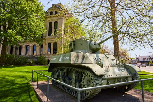 M4 Sherman tank at Kosciusko County Courthouse, Indiana, blending military heritage with urban architecture.