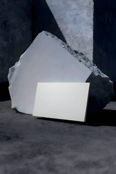 A blank white sheet of paper placed on a background of a large stone.