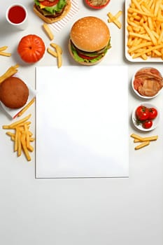 A clean white sheet, an empty canvas, encompassed by a tempting array of French fries and delectable fast food treats.