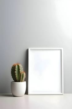 A white sheet of paper, framed and blank, rests beside a potted cactus, adding a touch of greenery.