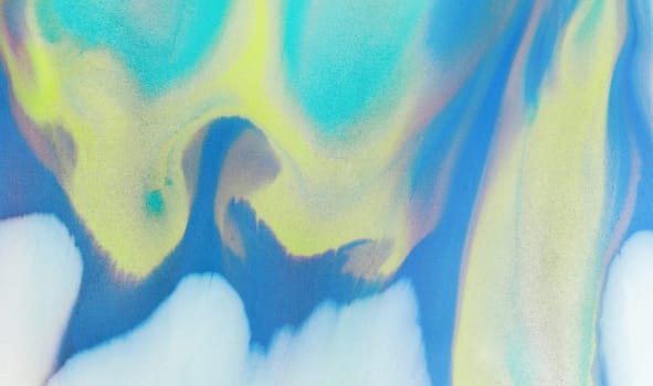 Swirls of vibrant blue, pink, and white merge fluidly, resembling an abstract wave under the soft, glowing light of late afternoon.