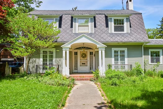 Serene suburban home in Fort Wayne, Indiana, nestled among lush greenery with classic architectural charm.