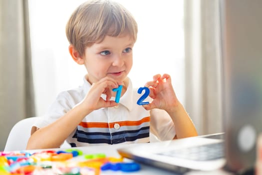 A cheerful young boy concentrates on learning numbers with colorful educational toys, a moment of playful learning in a vibrant home setting