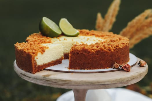 A decadent slice of lime cheesecake resting on a pristine white plate, showcasing a perfect balance of creamy texture and zesty flavor.