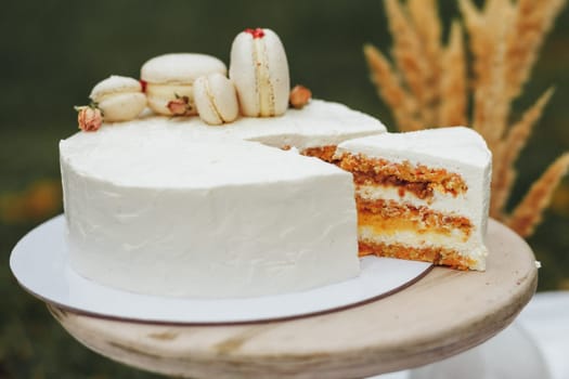 A white cake with a slice missing, revealing its fluffy interior and decadent layers.