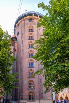 The Round Tower and Trinitatis Church in Copenhagen. Famous landmark in Copenhagen, Denmark - September 30, 2023.