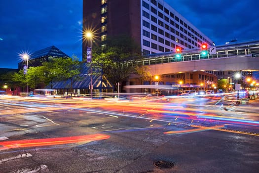 Twilight buzz at Downtown Fort Wayne, capturing vibrant light trails and modern city life against the Hilton backdrop.