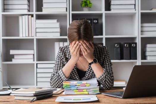 Young businesswoman has problems with her work in the office Feeling stressed and unhappy, showing a serious expression.