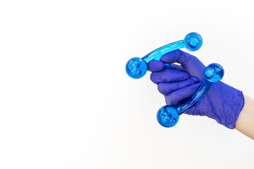 Mockup Human Gloved Hand Holds Blue Acrylic Back, Leg, Neck Massage Tool. Deep Tissue Massage, Thumb Massager with Knobs for Gentle Point, Muscles Relaxation. Design, Copy Space. Horizontal Plane.