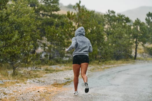 Rain or shine, a dedicated marathoner powers through her training run, her eyes set on the finish line.