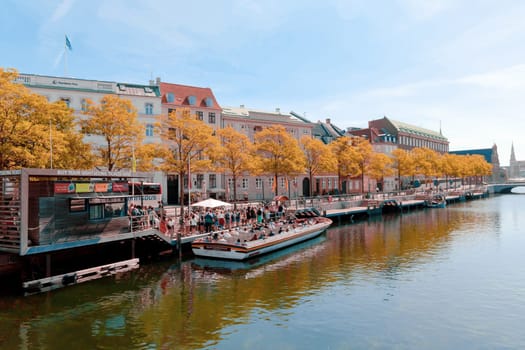 Beautiful historical center of Copenhagen with ancient buildings and a water canal with boats. Copenhagen, Denmark - Novemner 17, 2023