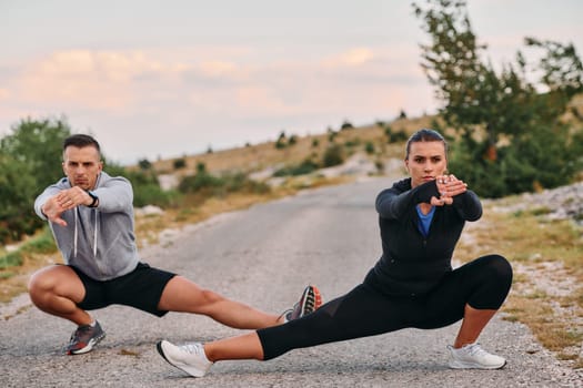 A romantic couple stretches after a tiring morning run