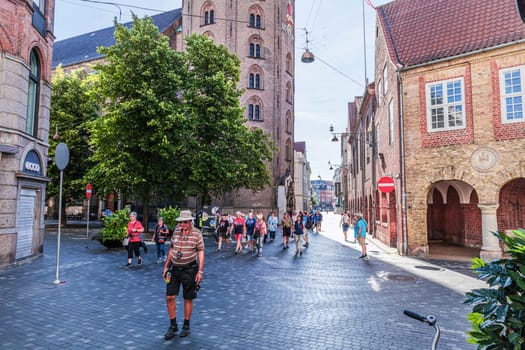 Tourists on the street in the old town of Copenhagen on a sunny summer day. Copenhagen, Denmark