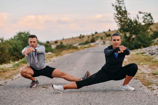 A romantic couple stretches after a tiring morning run