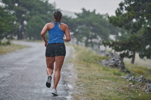 Rain or shine, a dedicated marathoner powers through her training run, her eyes set on the finish line.