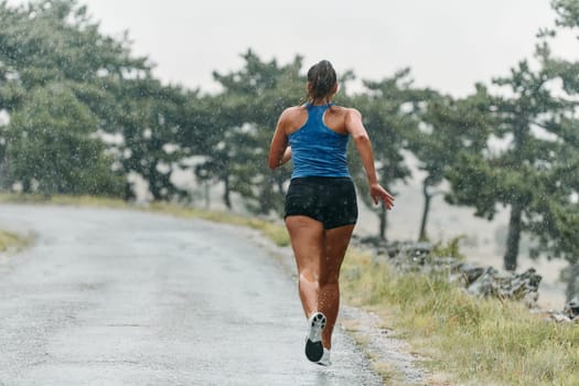 Rain or shine, a dedicated marathoner powers through her training run, her eyes set on the finish line.