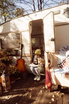 A chic, modern hippie woman enjoys a hot drink on the house terrace, radiating elegance. High quality photo