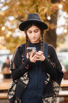 A stunning young lady radiating beauty in her black outfit and hat. High quality photo