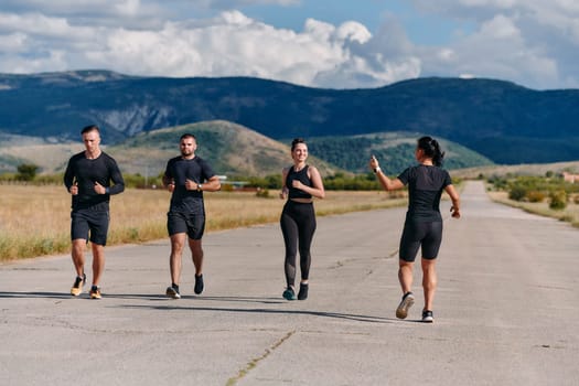 A professional athletic team as they train rigorously, running towards peak performance in preparation for an upcoming marathon.