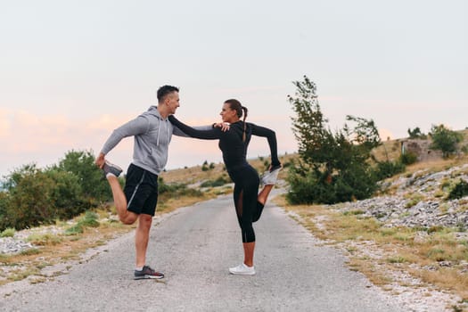 A romantic couple stretches after a tiring morning run