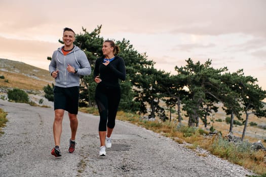 Couple conquer challenging mountain trails during an invigorating morning run.