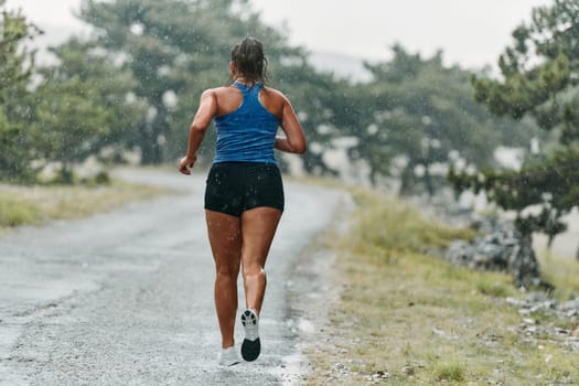 Rain or shine, a dedicated marathoner powers through her training run, her eyes set on the finish line.