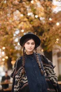 A fashionable young woman dressed elegantly in black with a hat. High quality photo