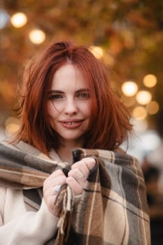 A charismatic redhead embracing bohemian chic on a colorful autumn day. High quality photo