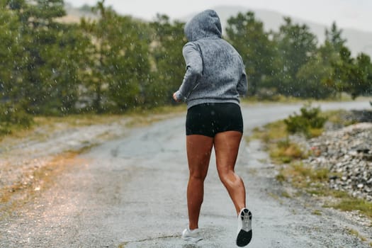 Rain or shine, a dedicated marathoner powers through her training run, her eyes set on the finish line.