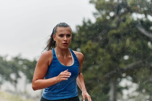 Rain or shine, a dedicated marathoner powers through her training run, her eyes set on the finish line.