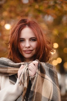 A fiery-haired beauty embracing a hippie aesthetic amidst the autumn landscape. High quality photo