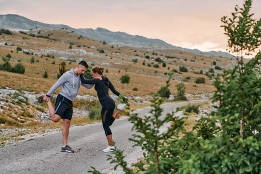 A romantic couple stretches after a tiring morning run