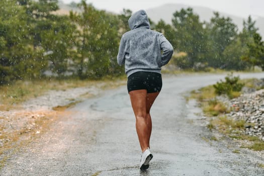 Rain or shine, a dedicated marathoner powers through her training run, her eyes set on the finish line.