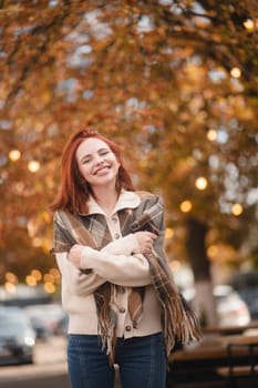 A jubilant redhead beams with laughter, lighting up the autumn city streets. High quality photo