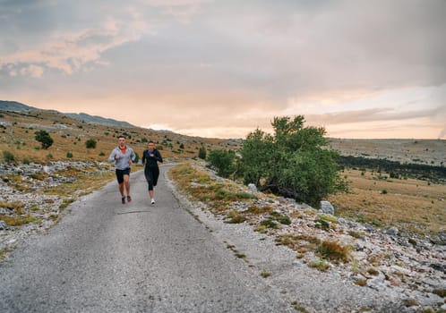 Couple conquer challenging mountain trails during an invigorating morning run.