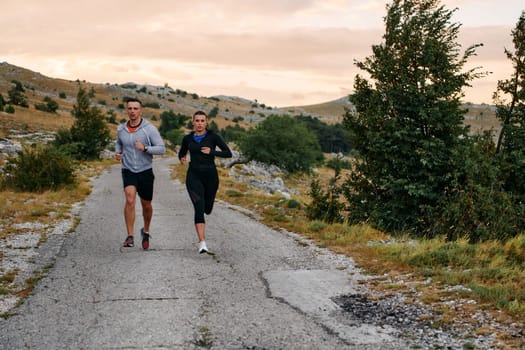 Couple conquer challenging mountain trails during an invigorating morning run.