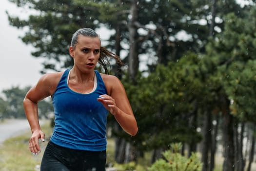 Rain or shine, a dedicated marathoner powers through her training run, her eyes set on the finish line.