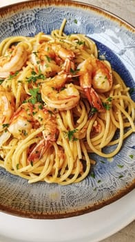 Pasta with shrimps, tomatoes and basil on a plate