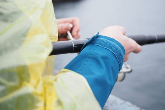 Fisherman with rod, spinning reel