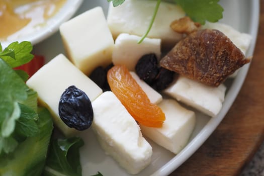Cheese platter with dry food on a plate ,