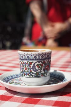 a cup of turkish coffee on table .